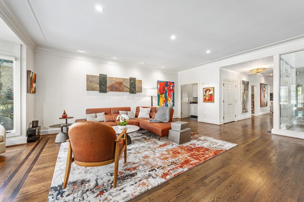Living area open to the wide hallway to atrium, dining room, kitchen and sitting area.