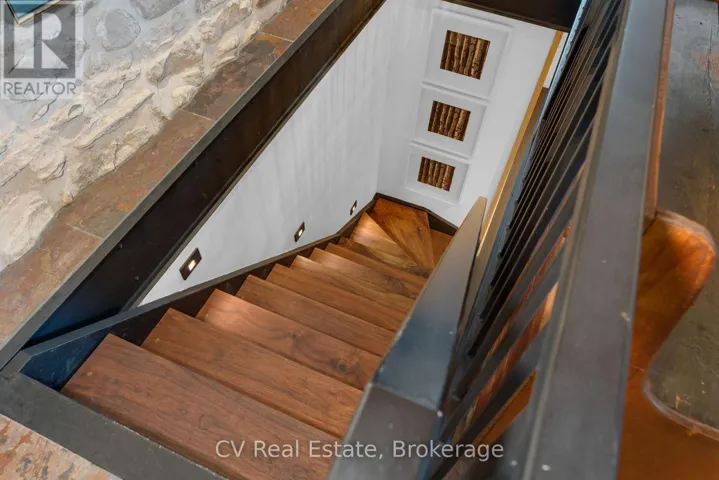 Walnut staircase leads to finished lower level