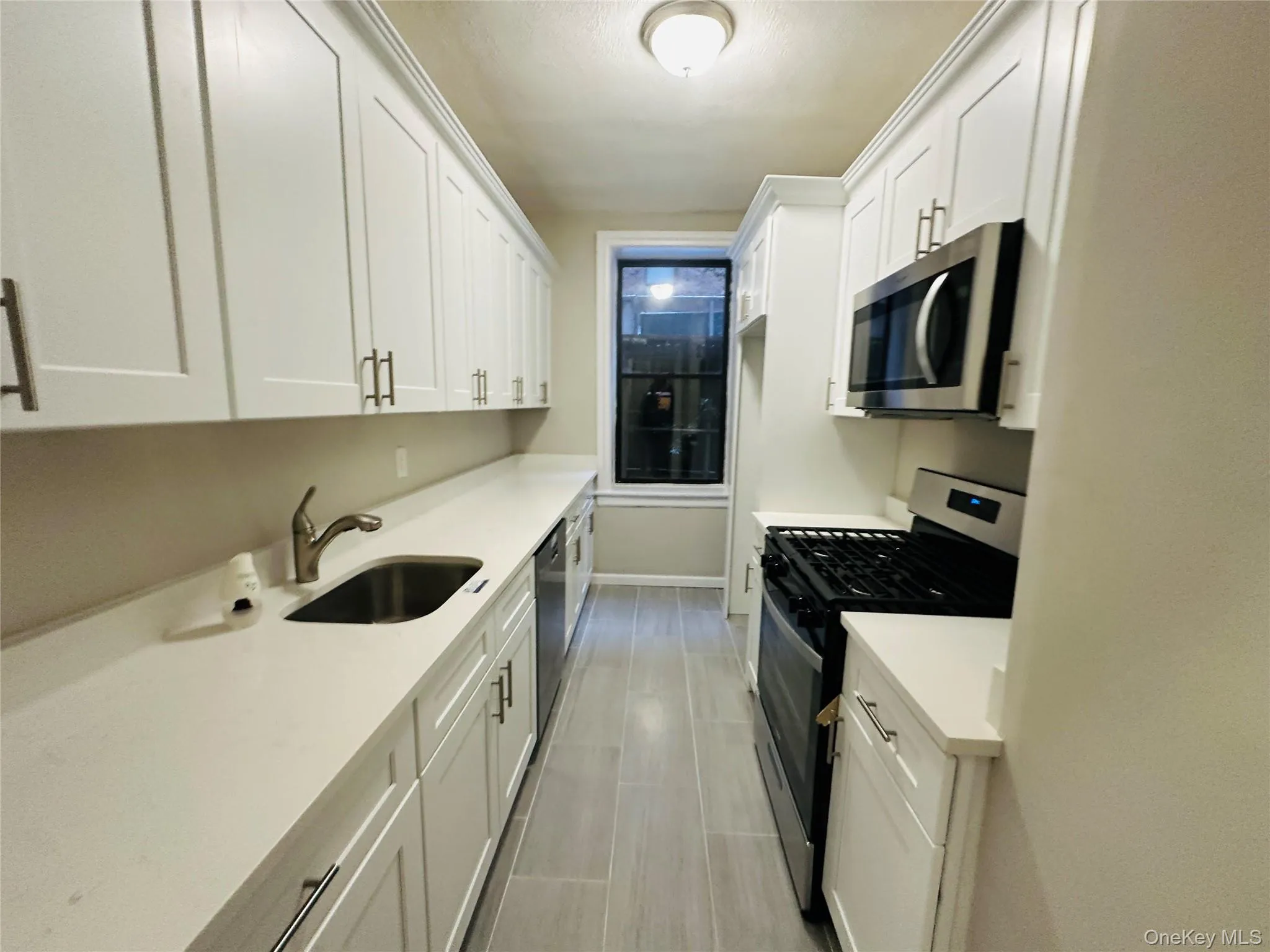 Kitchen with white cabinets, stainless steel appliances, and sink Kitchen with white cabinets, stainless steel appliances, and sink