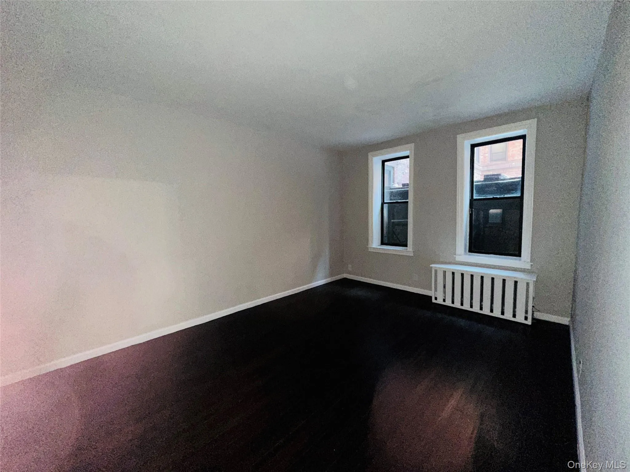 Spare room featuring radiator heating unit and a textured ceiling Spare room featuring radiator heating unit and a textured ceiling