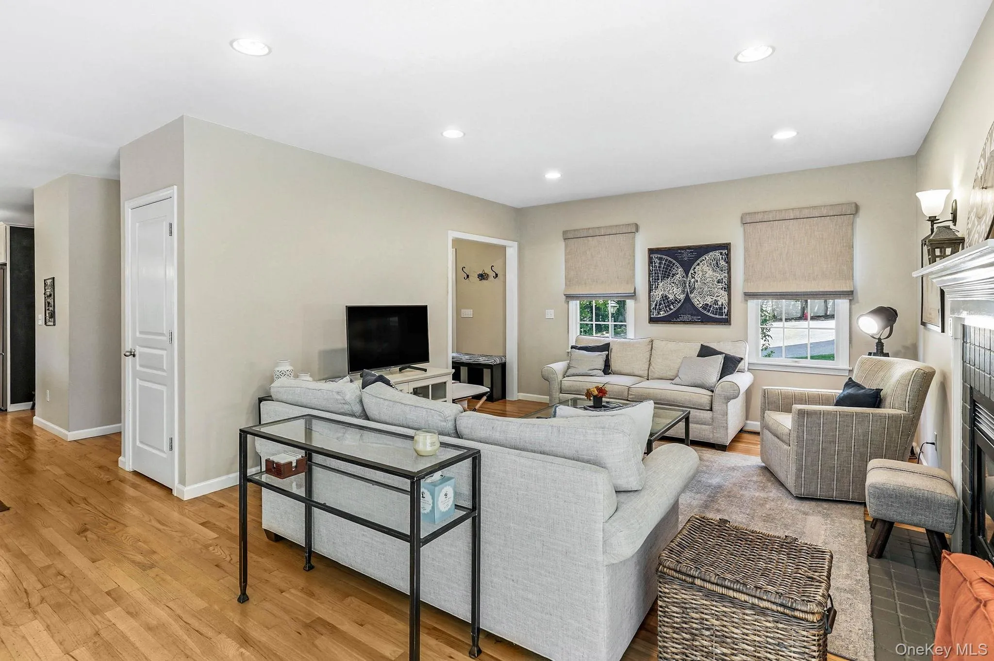 Open living area featuring wood-finish flooring and recessed lighting Open living area featuring wood-finish flooring and recessed lighting