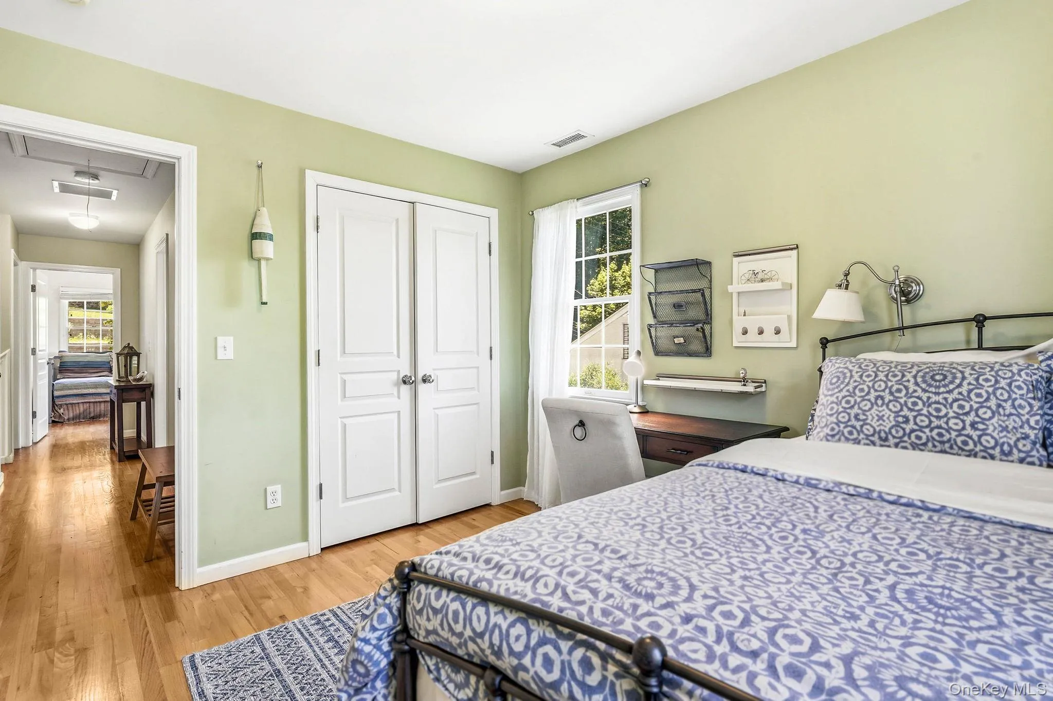 Light green walls complement natural wood-finish flooring throughout this room Light green walls complement natural wood-finish flooring throughout this room