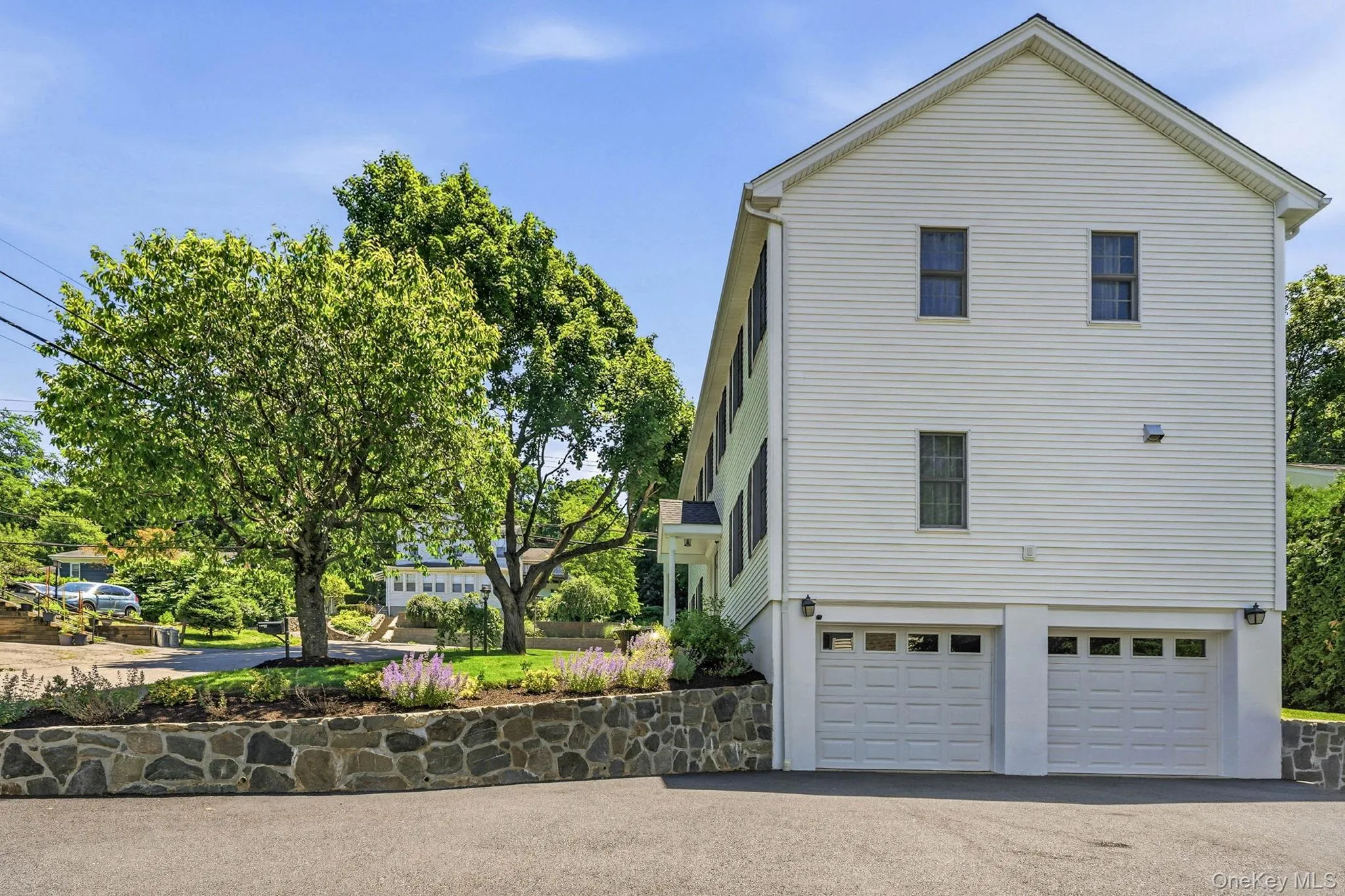 White siding exterior with a two-car garage White siding exterior with a two-car garage