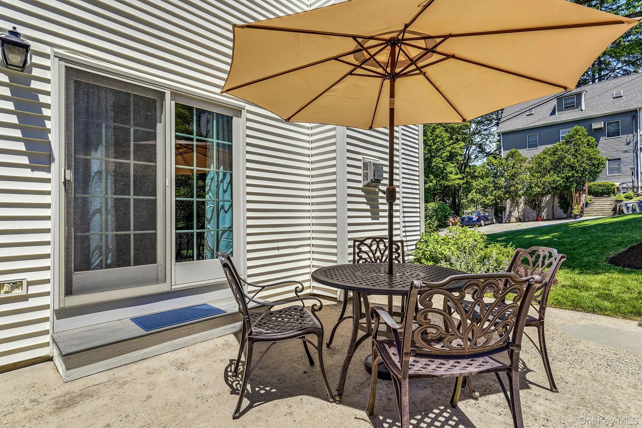 Private concrete patio featuring a sliding glass door entry Private concrete patio featuring a sliding glass door entry