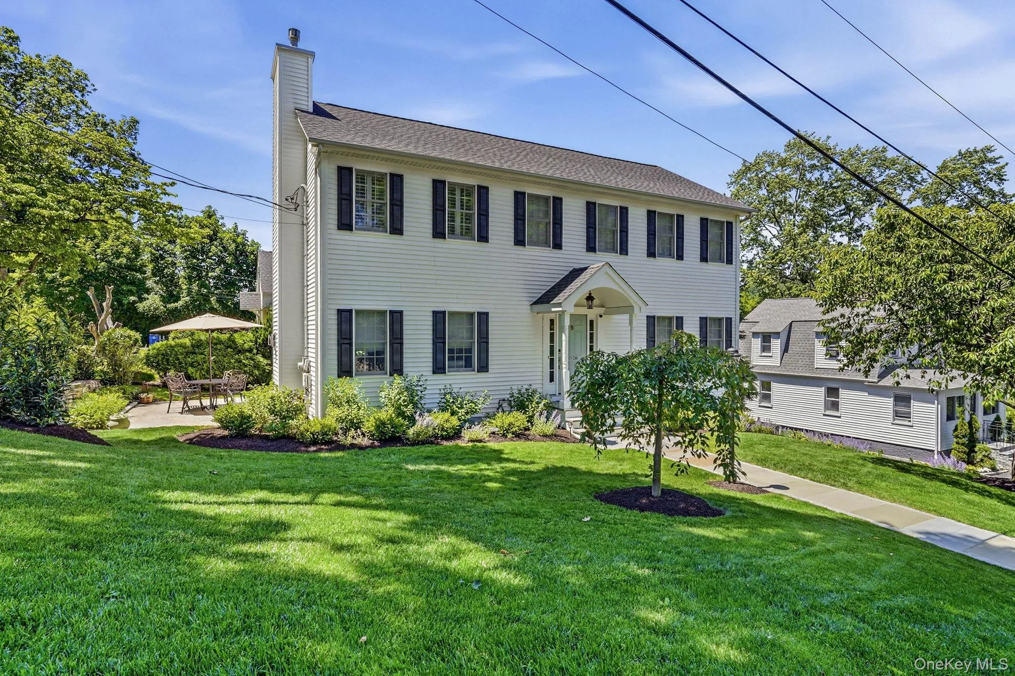 White two-story residence with black shutters White two-story residence with black shutters