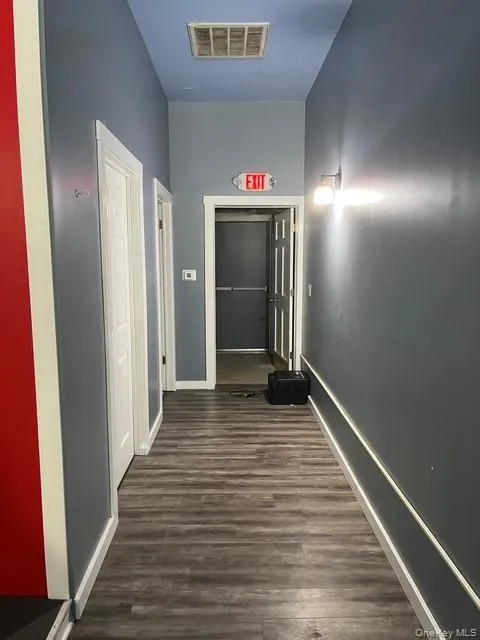 Corridor with dark wood-style flooring Corridor with dark wood-style flooring