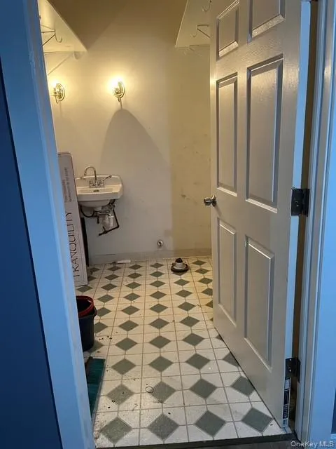 Bathroom featuring baseboards and a sink Bathroom featuring baseboards and a sink