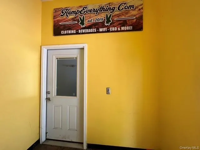 Doorway to outside featuring baseboards Doorway to outside featuring baseboards