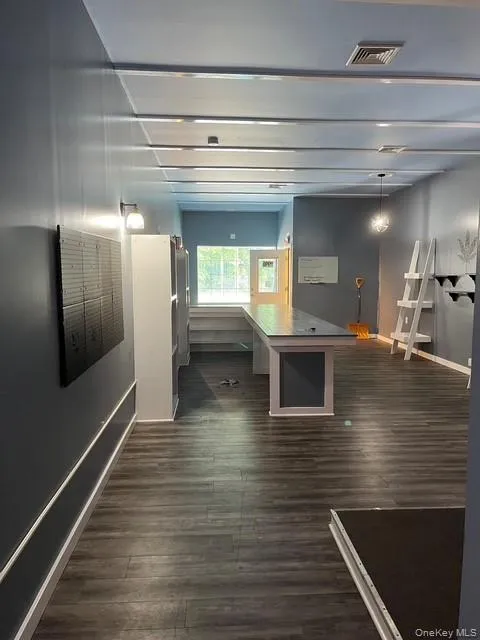 Game room with dark wood-type flooring and baseboards Game room with dark wood-type flooring and baseboards