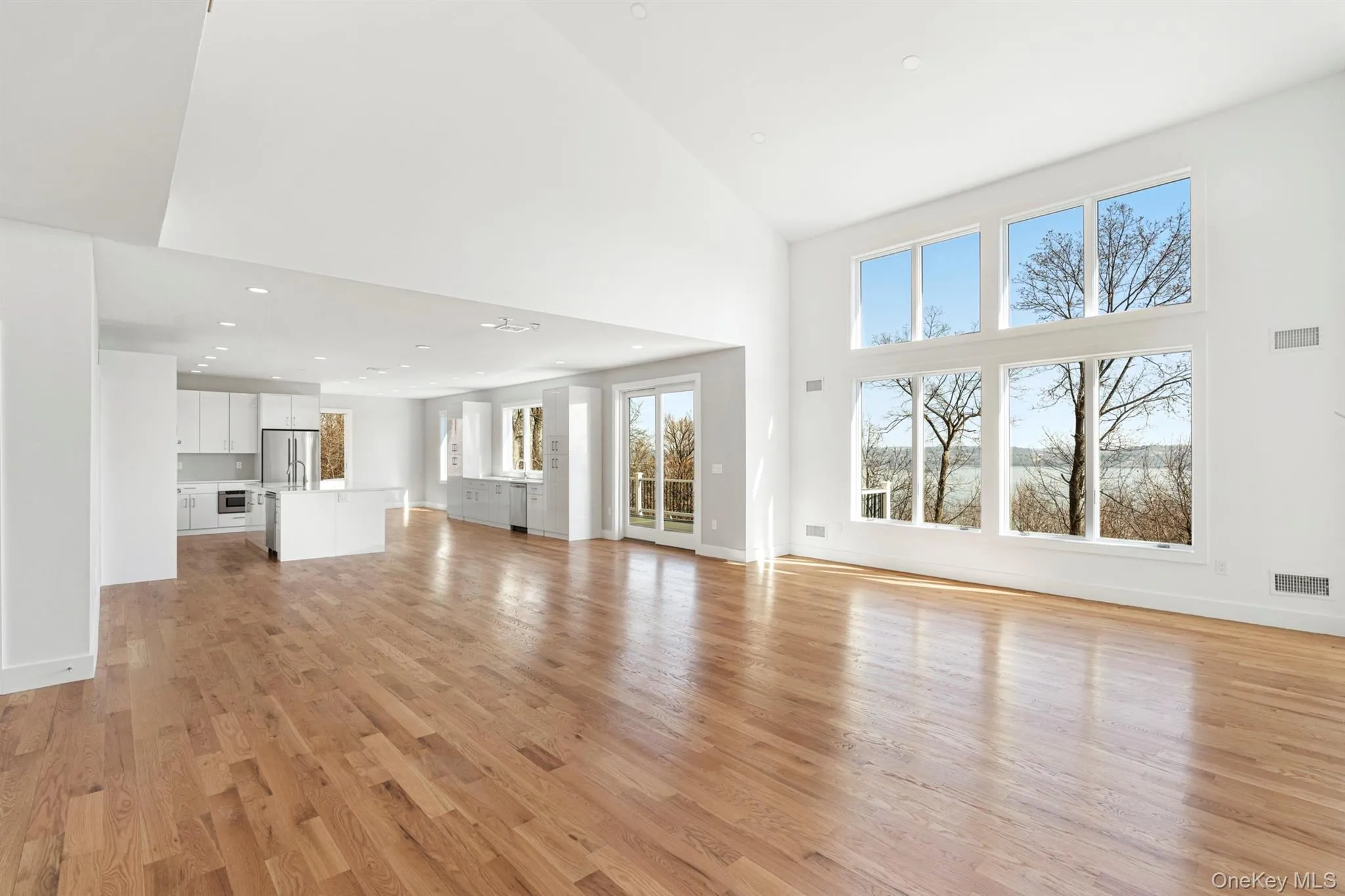 Hardwood floors, cathedral ceilings with deck access and open to Chef's Kitchen Hardwood floors, cathedral ceilings with deck access and open to Chef's Kitchen