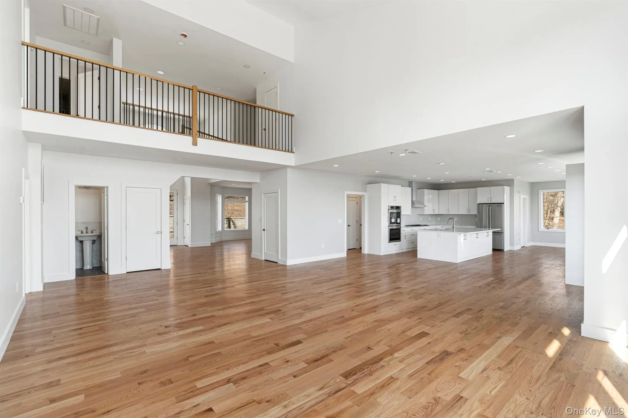 Looking toward the kitchen with 2nd floor landing overlook Looking toward the kitchen with 2nd floor landing overlook