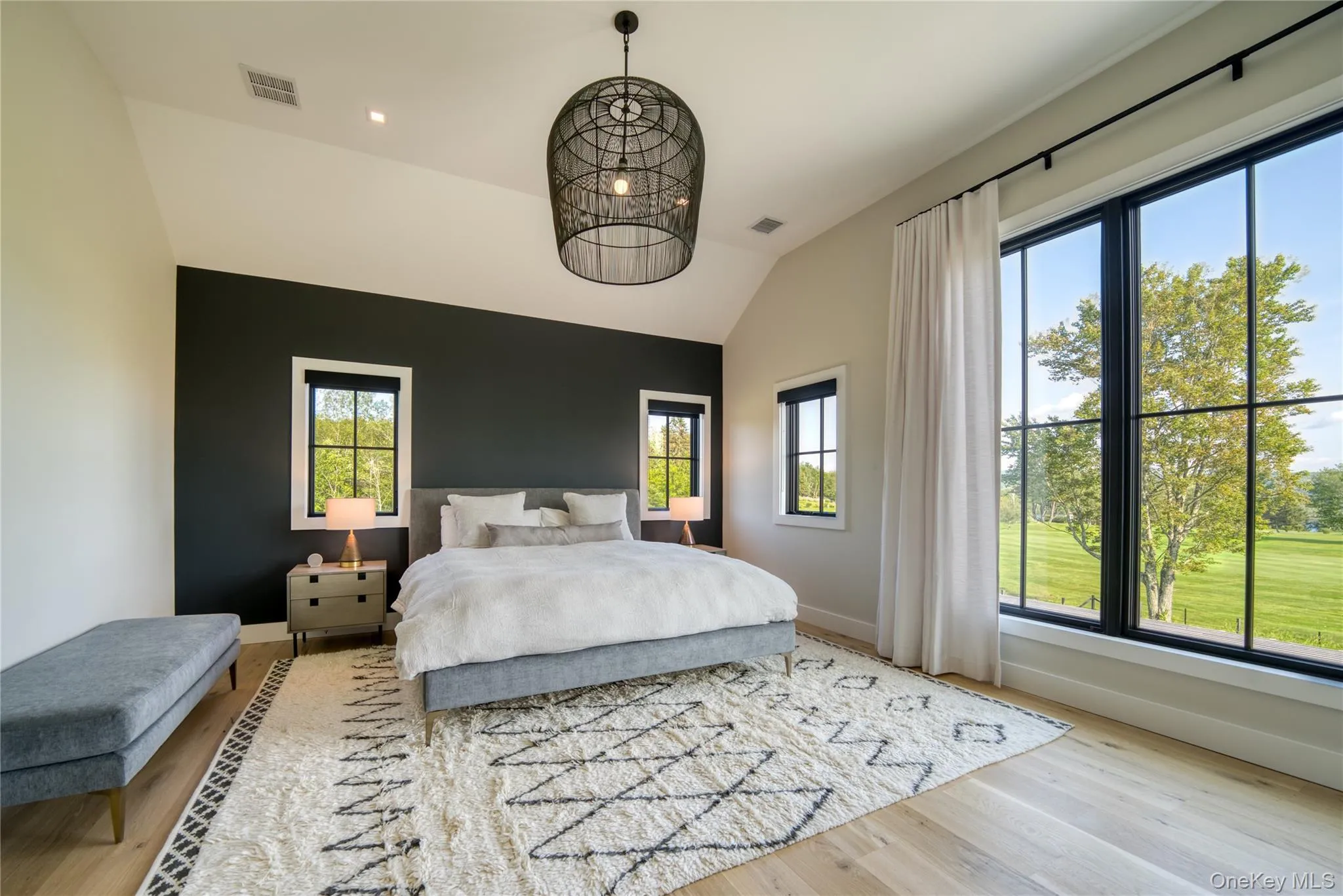 Bedroom with lofted ceiling and hardwood / wood-style floors Bedroom with lofted ceiling and hardwood / wood-style floors