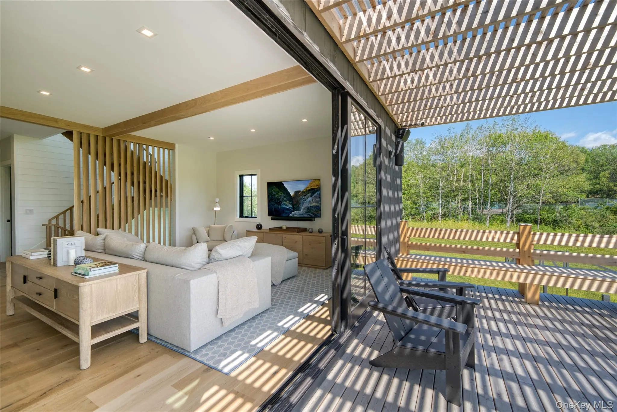 Indoor/outdoor main level family room with sliders open to expansive deck Indoor/outdoor main level family room with sliders open to expansive deck