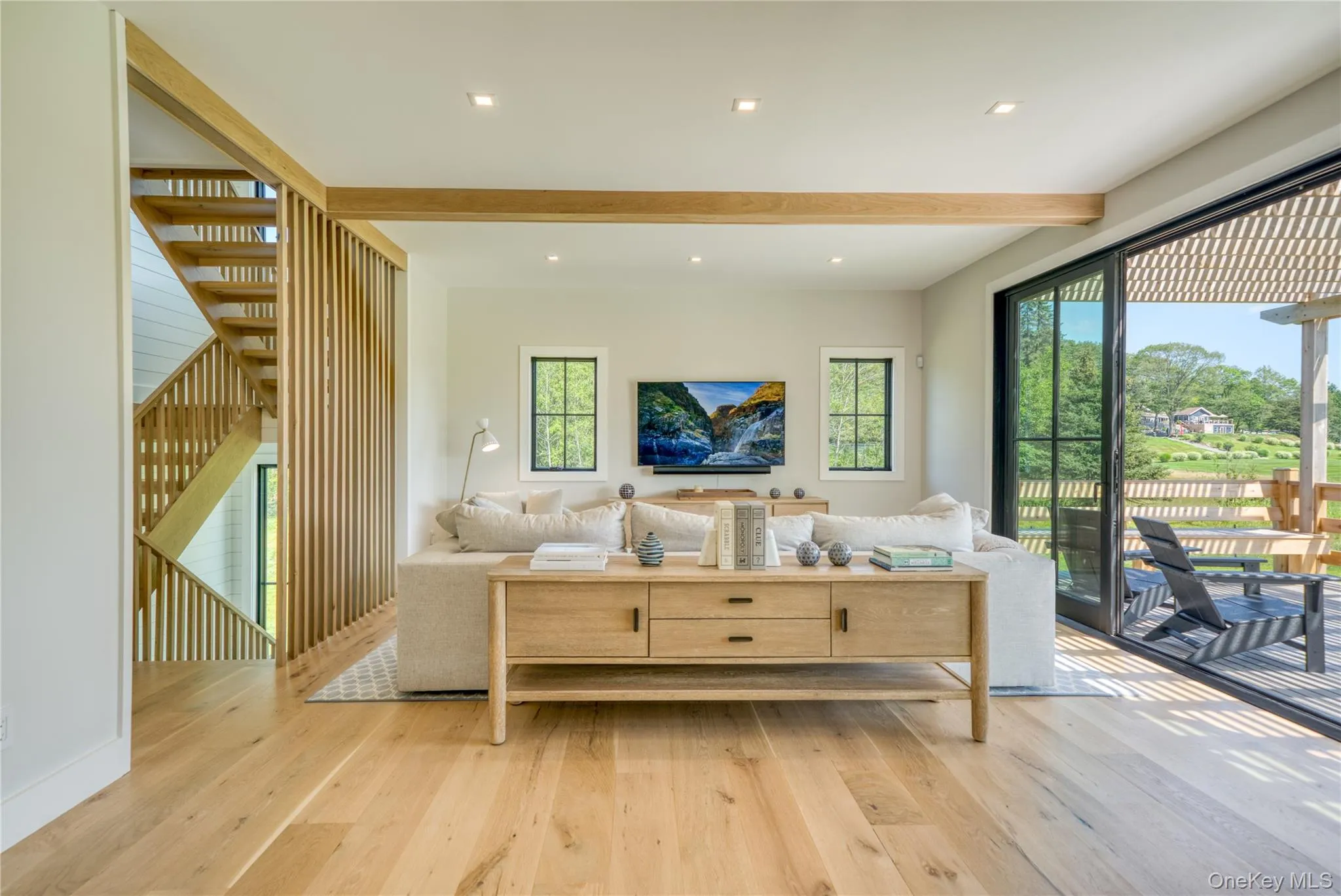 Main level family room with sliders to porch and a table Main level family room with sliders to porch and a table