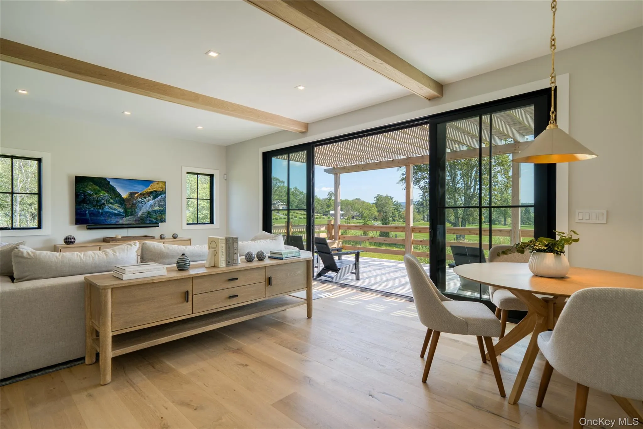 Main level family room featuring beamed ceiling and hardwood floors Main level family room featuring beamed ceiling and hardwood floors