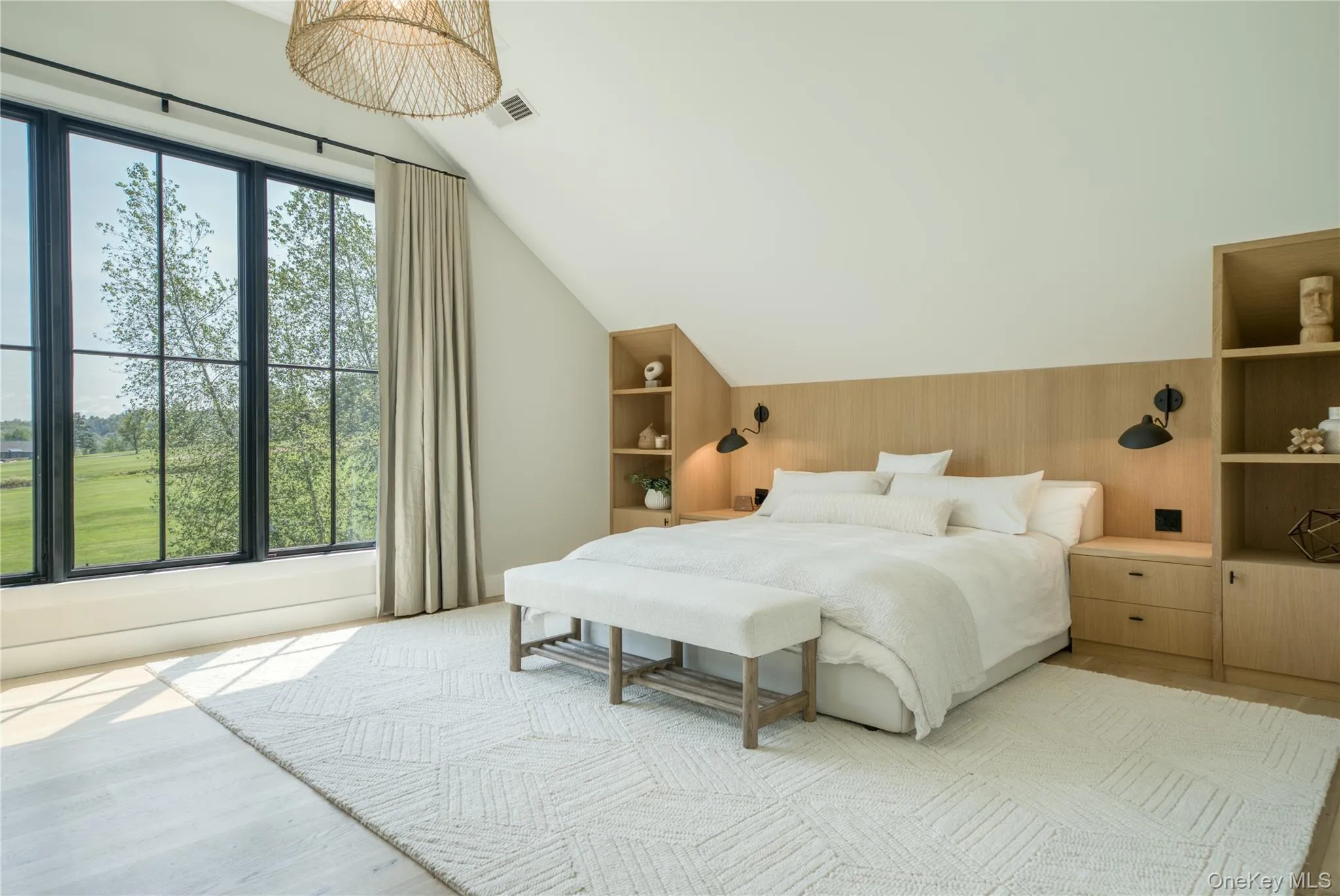Bedroom featuring light hardwood / wood-style flooring, wood walls, and vaulted ceiling Bedroom featuring light hardwood / wood-style flooring, wood walls, and vaulted ceiling