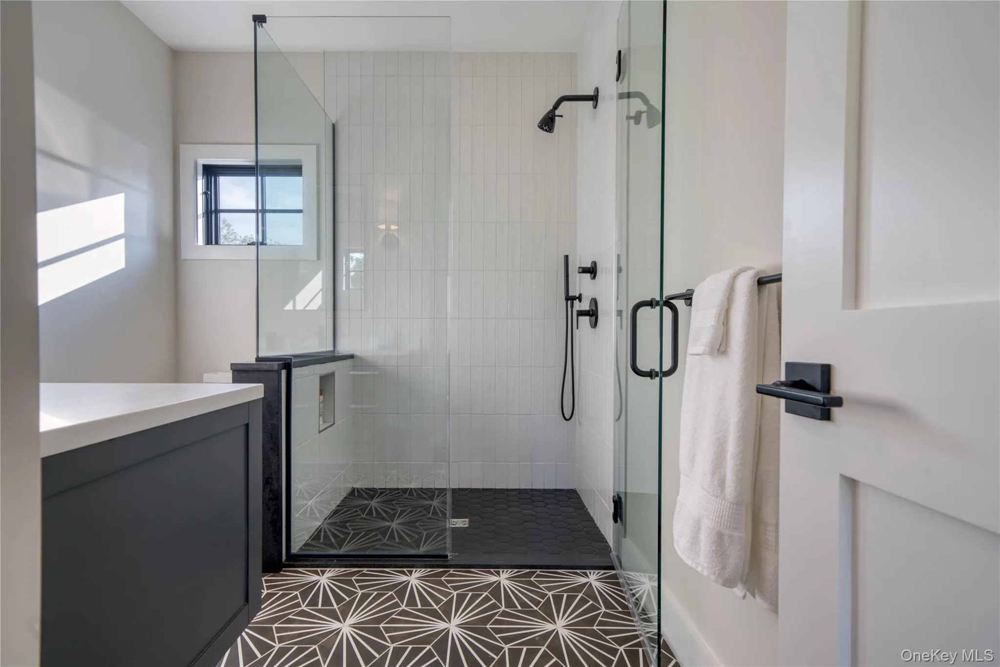 Bathroom featuring vanity and a shower with door Bathroom featuring vanity and a shower with door