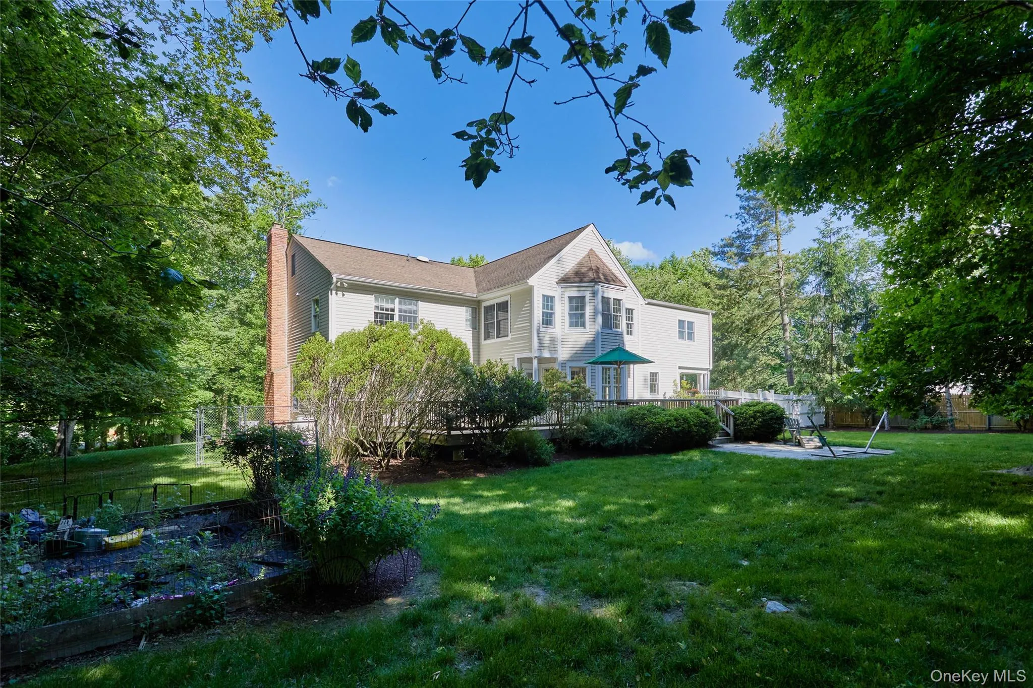 Completely fenced in beautiful yard with patio and gardening beds Completely fenced in beautiful yard with patio and gardening beds