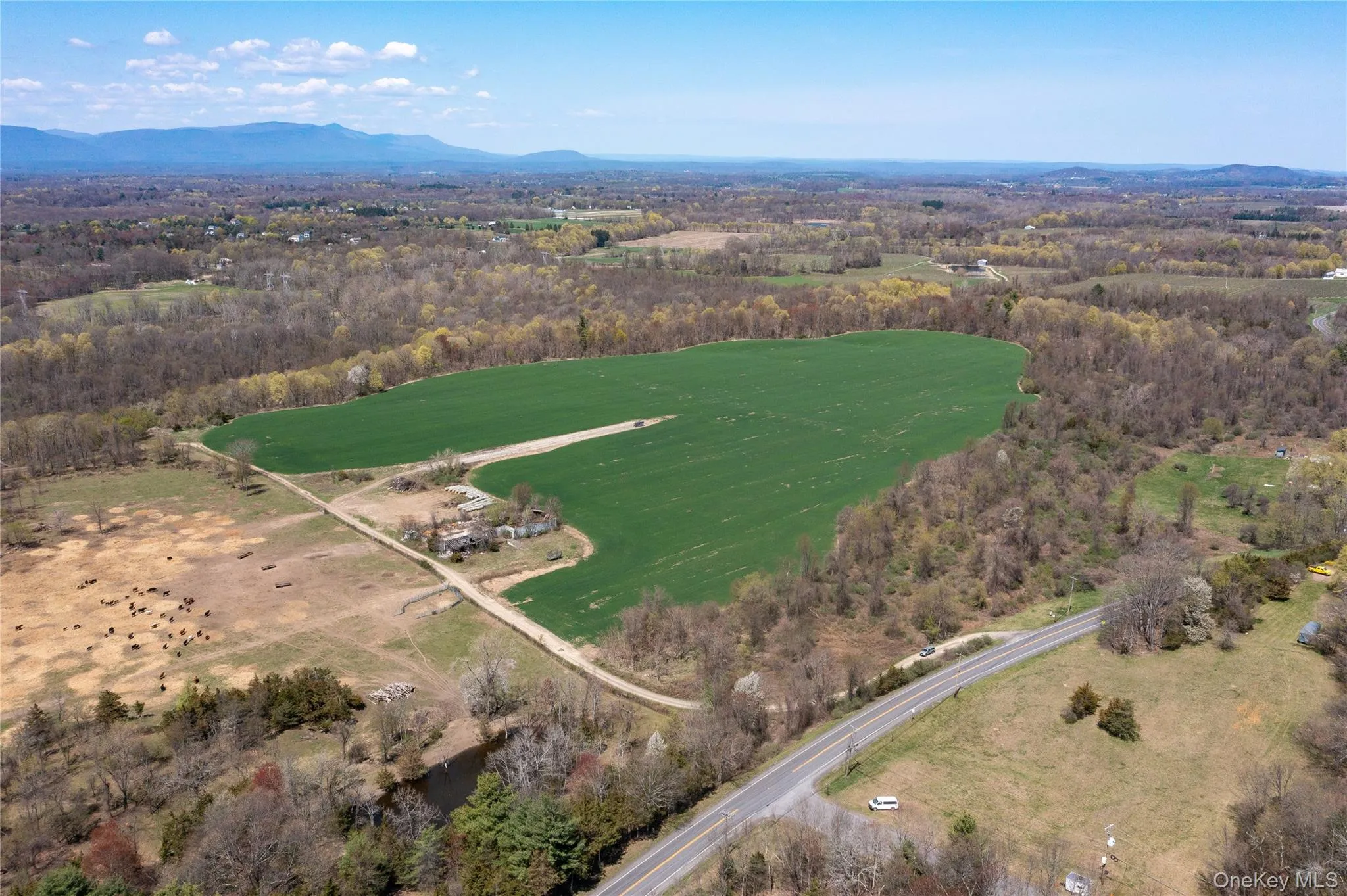 Aerial overview of property's location featuring a mountainous background Aerial overview of property's location featuring a mountainous background
