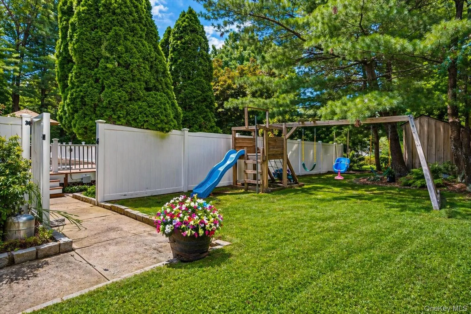 Side yard with playset. Side yard with playset.