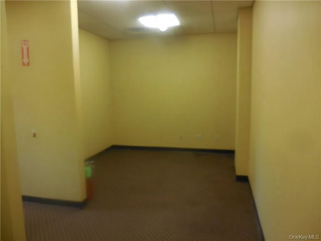 Spare room featuring dark carpet Spare room featuring dark carpet