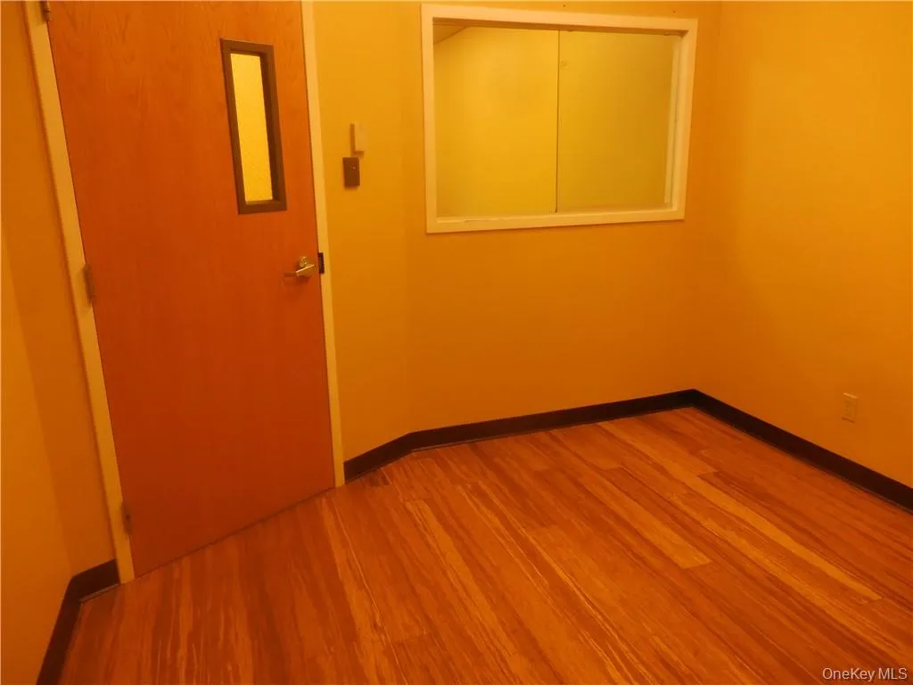 Unfurnished room featuring hardwood / wood-style flooring Unfurnished room featuring hardwood / wood-style flooring