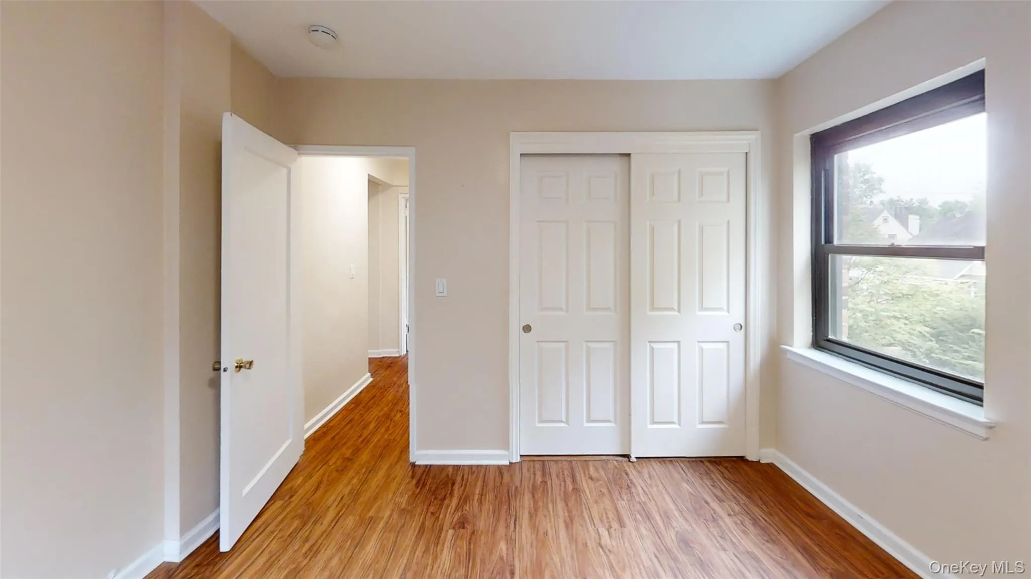 Unfurnished bedroom with a closet, light wood-style floors, and baseboards Unfurnished bedroom with a closet, light wood-style floors, and baseboards