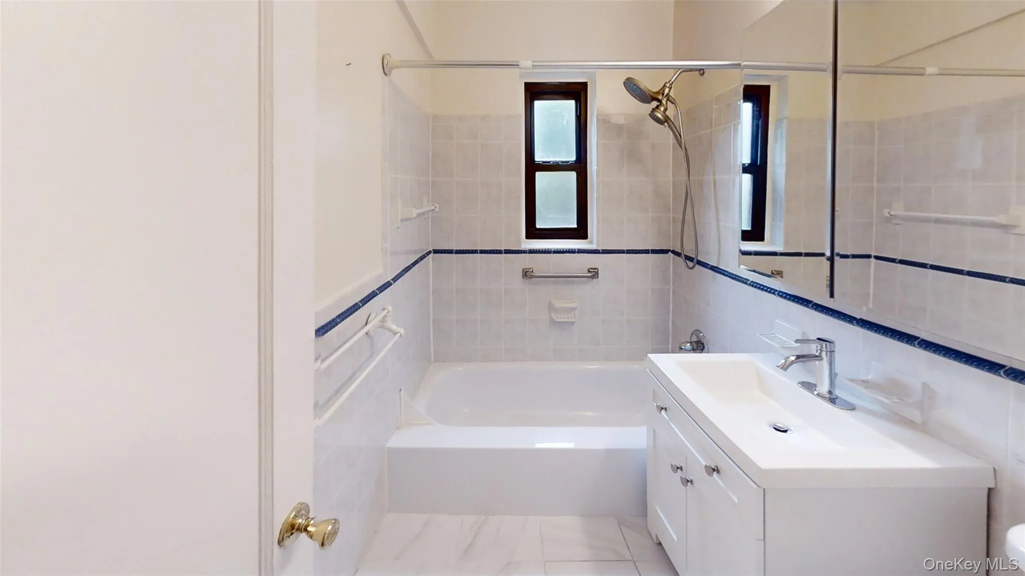 Full bath featuring vanity, tile walls, and toilet Full bath featuring vanity, tile walls, and toilet
