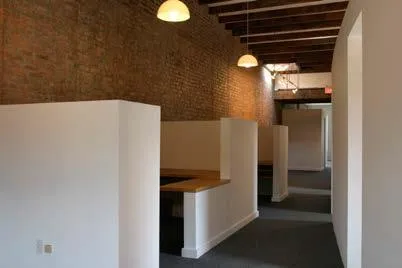 Partitioned private office area w/brick wall Partitioned private office area w/brick wall