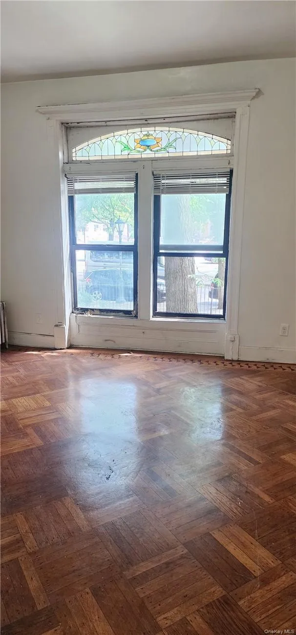 Empty room featuring dark parquet floors Empty room featuring dark parquet floors