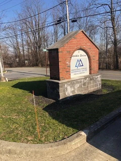 Community sign featuring a yard Community sign featuring a yard