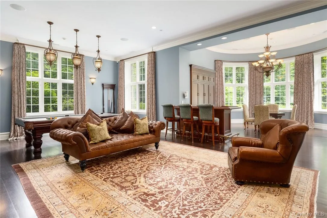 Garden Level Entertaining Space with fireplace, billiard table, multiple seating arragements and bar in the garden level Garden Level Entertaining Space with fireplace, billiard table, multiple seating arragements and bar in the garden level