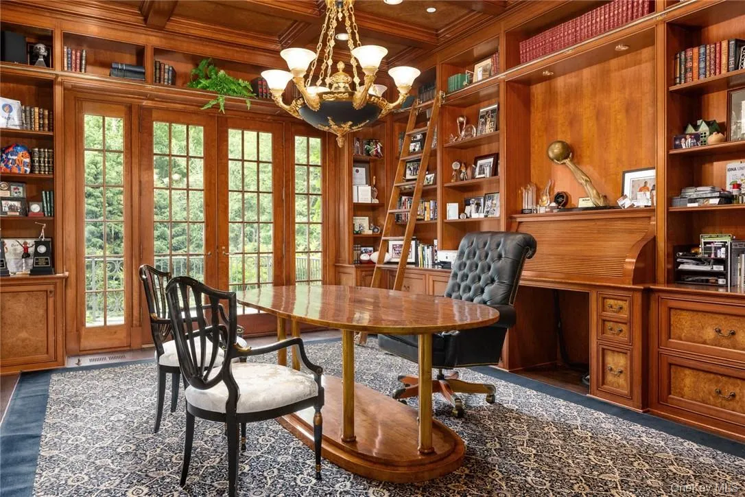 Large office/library with full bath and conference room featuring exquisite wood paneling and built-ins Large office/library with full bath and conference room featuring exquisite wood paneling and built-ins