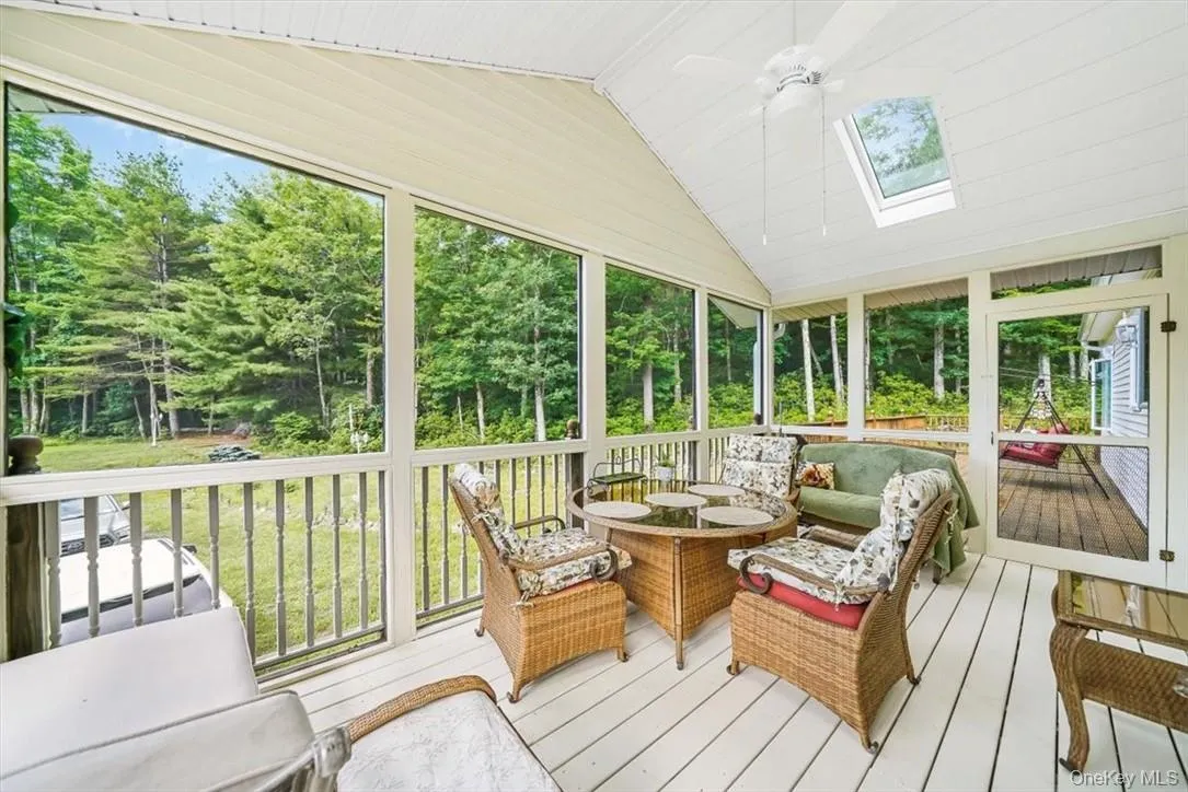 Sunroom / solarium with vaulted ceiling with skylight and ceiling fan Sunroom / solarium with vaulted ceiling with skylight and ceiling fan