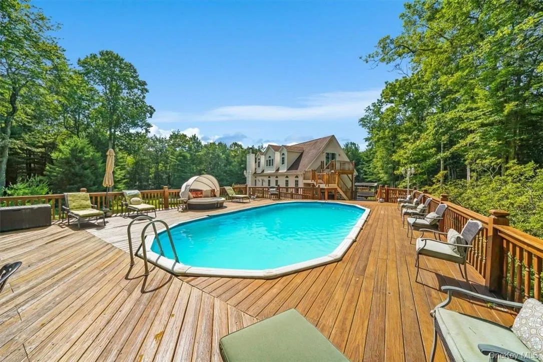 View of pool with a wooden deck View of pool with a wooden deck