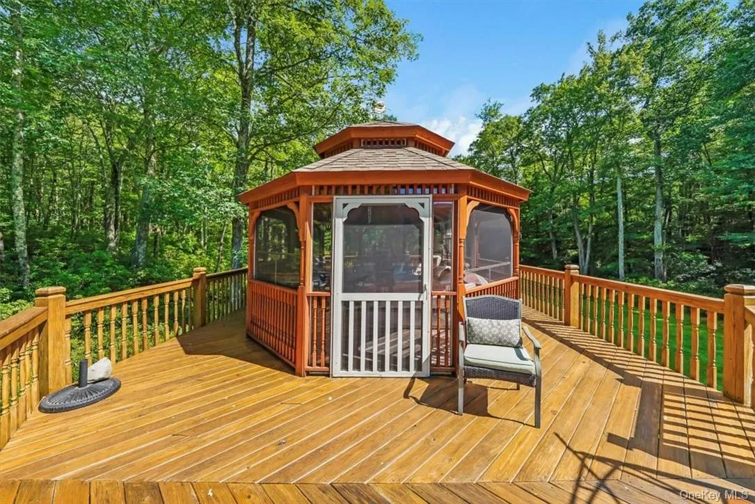 Wooden terrace featuring a gazebo Wooden terrace featuring a gazebo