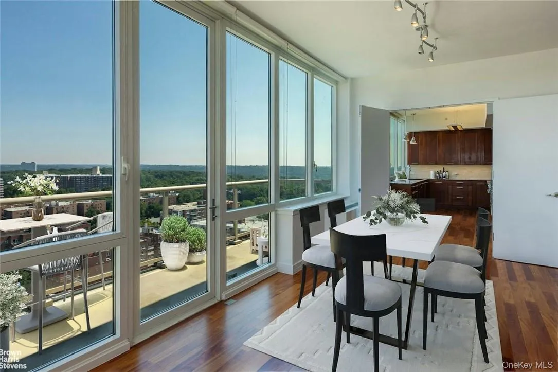 Dining space with rail lighting and hardwood / wood-style floors Dining space with rail lighting and hardwood / wood-style floors