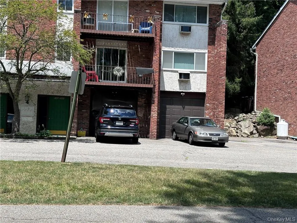 View of building exterior featuring a garage View of building exterior featuring a garage