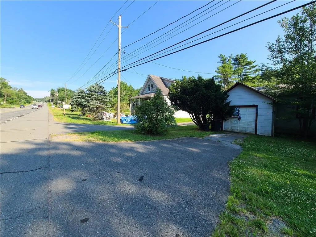 View of yard with a garage and an outbuilding View of yard with a garage and an outbuilding