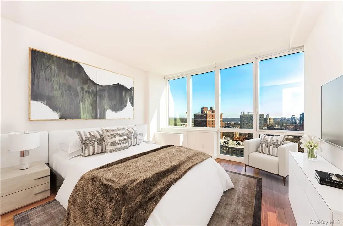Bedroom featuring a wall of windows and hardwood / wood-style flooring Bedroom featuring a wall of windows and hardwood / wood-style flooring