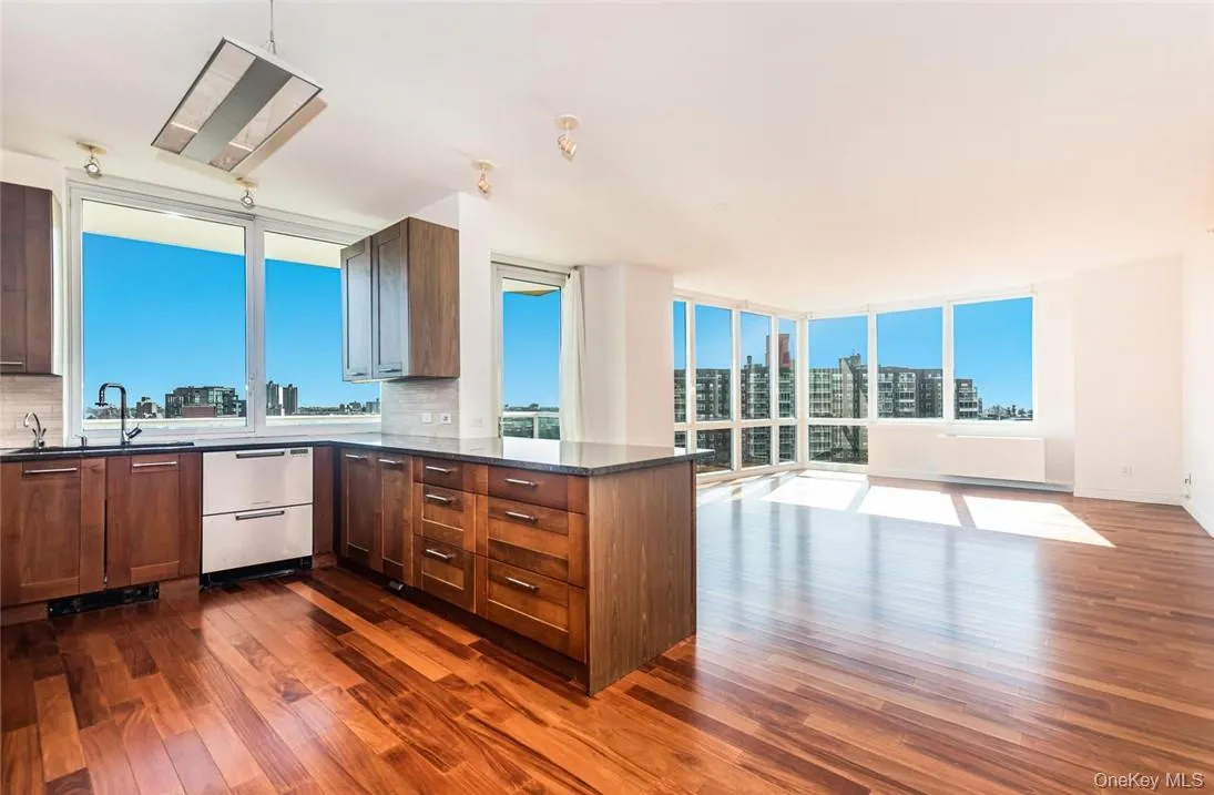 Kitchen featuring dark hardwood / wood-style floors, backsplash, and floor to ceiling windows Kitchen featuring dark hardwood / wood-style floors, backsplash, and floor to ceiling windows