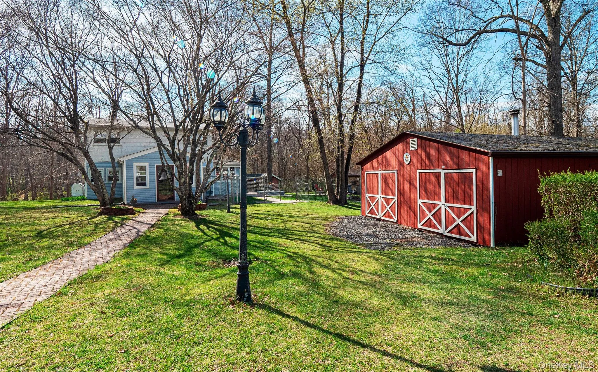 The spacious red structure can be used for a workshop, equipment storage, or a garage. The spacious red structure can be used for a workshop, equipment storage, or a garage.