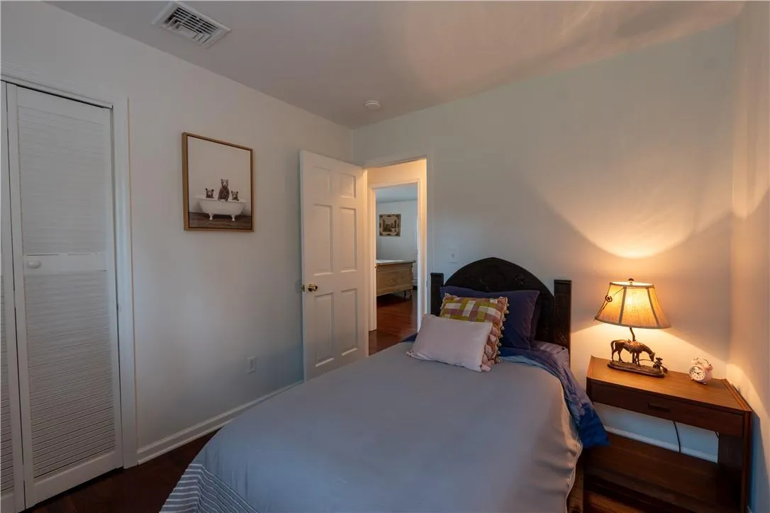 Bedroom with dark hardwood / wood-style floors and a closet Bedroom with dark hardwood / wood-style floors and a closet