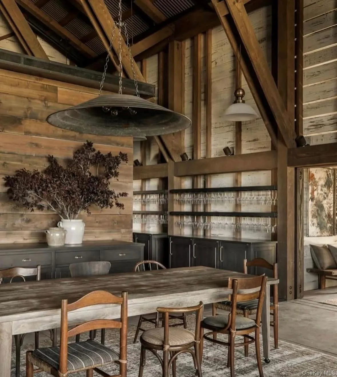 Bar featuring wooden walls and lofted ceiling Bar featuring wooden walls and lofted ceiling