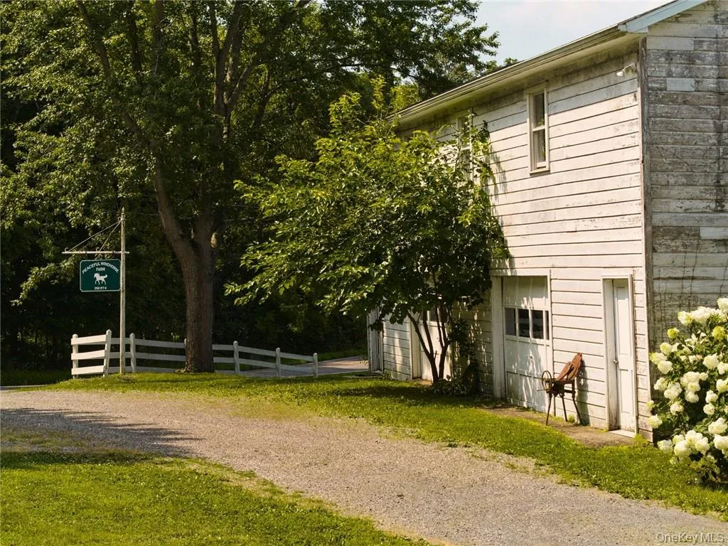 View of side of home featuring a garage View of side of home featuring a garage