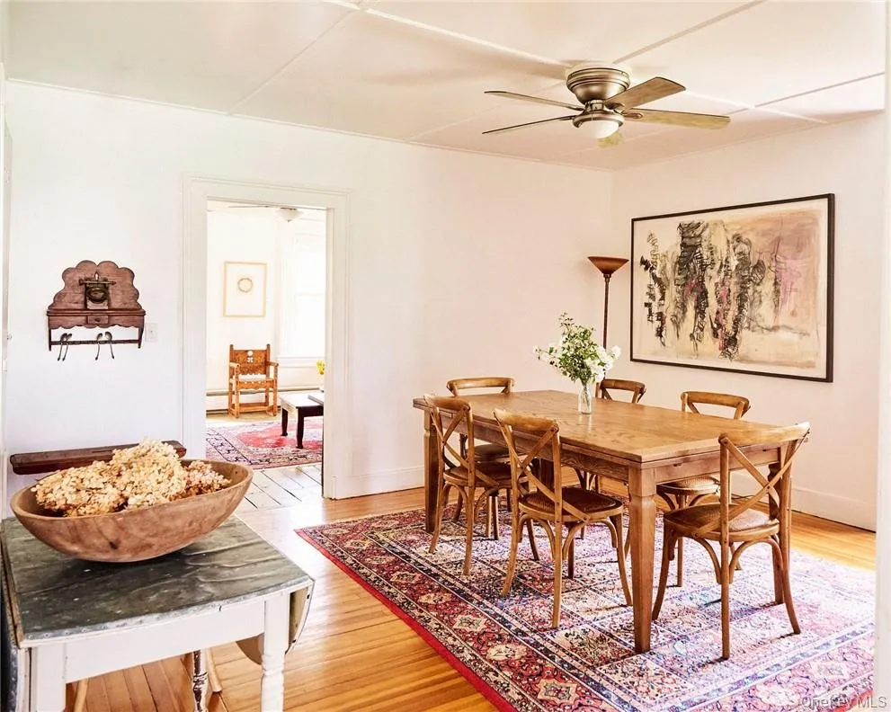 Dining room with ceiling fan and light hardwood / wood-style flooring Dining room with ceiling fan and light hardwood / wood-style flooring