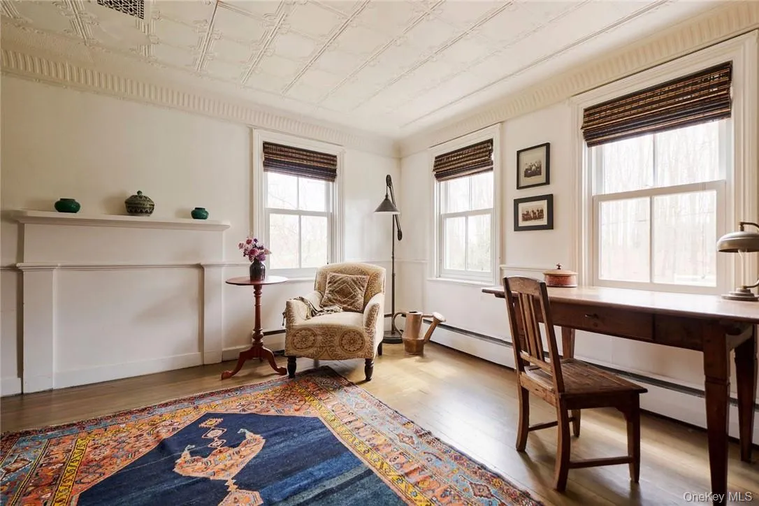 Living area with ornamental molding and hardwood / wood-style floors Living area with ornamental molding and hardwood / wood-style floors