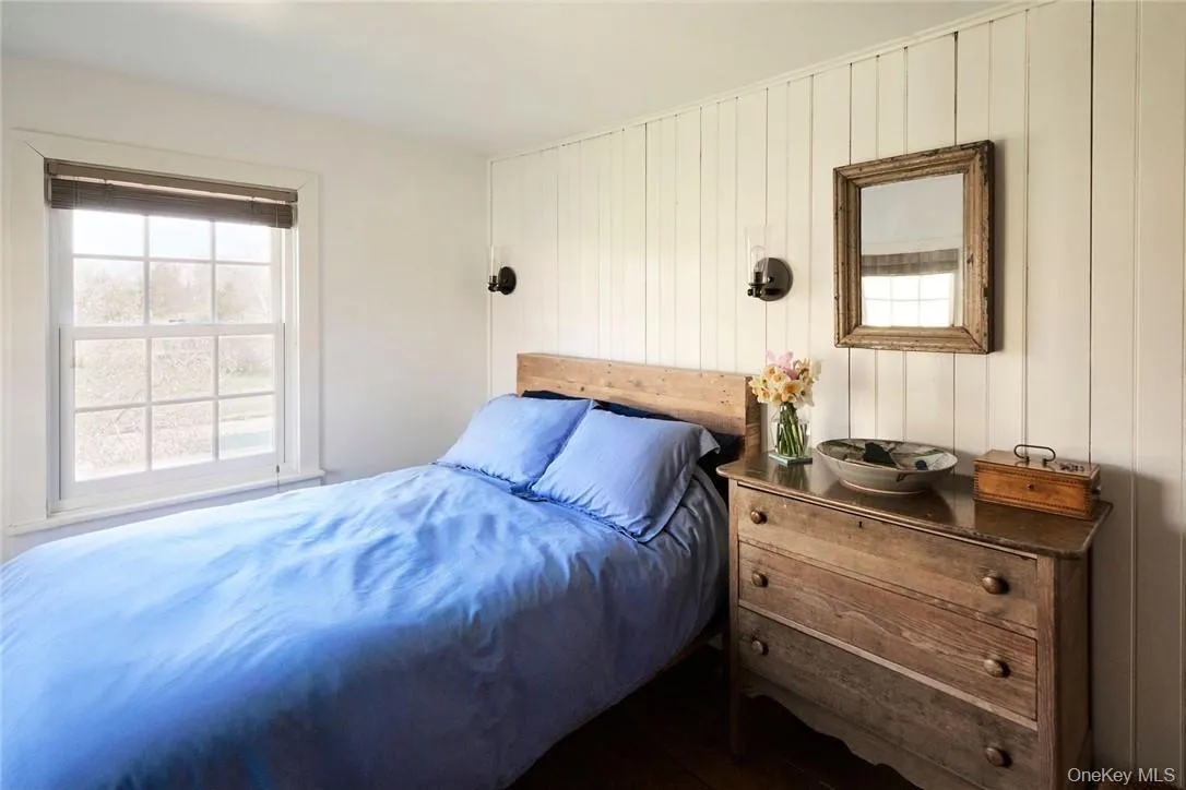 Bedroom featuring wooden walls Bedroom featuring wooden walls