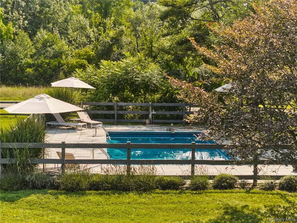 View of pool with a yard and a patio View of pool with a yard and a patio