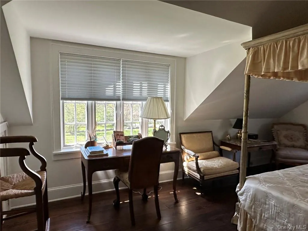Bedroom featuring dark hardwood / wood-style flooring Bedroom featuring dark hardwood / wood-style flooring